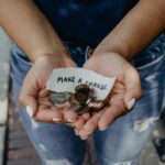 Hands holding coins for a charitable donation